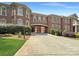 Brick home with gated entry and landscaping at 9100 Woodhall Lake Dr, Waxhaw, NC 28173