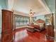 Luxurious main bedroom with hardwood floors and ornate furniture at 9100 Woodhall Lake Dr, Waxhaw, NC 28173