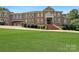 Brick home with gated entry and landscaping at 9100 Woodhall Lake Dr, Waxhaw, NC 28173