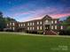 Brick house with large front yard, grand staircase, and gated entry at 9100 Woodhall Lake Dr, Waxhaw, NC 28173
