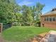 Private backyard with green lawn and brick fence at 9100 Woodhall Lake Dr, Waxhaw, NC 28173