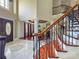 Grand entryway showcasing a curved staircase and stained glass door at 9100 Woodhall Lake Dr, Waxhaw, NC 28173