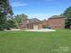 Large backyard with patio, three-car garage, and lush lawn at 9100 Woodhall Lake Dr, Waxhaw, NC 28173