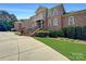 Brick home with gated entry and landscaping at 9100 Woodhall Lake Dr, Waxhaw, NC 28173