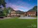 Brick house back view, showing patio, and a three car garage at 9100 Woodhall Lake Dr, Waxhaw, NC 28173