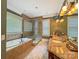 Spa-like bathroom with a soaking tub, walk-in shower, and granite vanity at 9100 Woodhall Lake Dr, Waxhaw, NC 28173