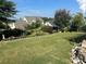 Landscaped backyard with tiered lawn and rock features at 2031 Masons Bend Dr, Fort Mill, SC 29708