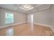 Bedroom with hardwood floors, tray ceiling and access to bathroom at 3921 Sky Dr, Charlotte, NC 28226