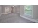 Large bedroom with carpet and window at 3921 Sky Dr, Charlotte, NC 28226