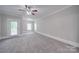 Bright bedroom with carpeting, ceiling fan and access to balcony at 3921 Sky Dr, Charlotte, NC 28226