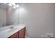 Small bathroom with single sink vanity, toilet and mirror at 3921 Sky Dr, Charlotte, NC 28226
