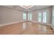 Bedroom with hardwood floors, double doors to balcony and tray ceiling at 3921 Sky Dr, Charlotte, NC 28226