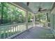 Screened porch overlooking wooded backyard with ceiling fan at 3921 Sky Dr, Charlotte, NC 28226