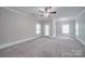 Spacious bedroom with ceiling fan and door at 3921 Sky Dr, Charlotte, NC 28226