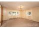 Bright living room with carpet, windows, and chandelier at 502 Hyde St, Kannapolis, NC 28083