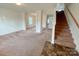 Spacious living room with neutral carpeting and staircase at 3800 Hope Marian St, Gastonia, NC 28052