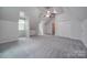 Large bedroom with sloped ceilings, carpet, and double doors to closet at 6232 Hickory Cove Ln, Charlotte, NC 28269