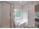 Bathroom includes a bathtub, shower, and window at 6232 Hickory Cove Ln, Charlotte, NC 28269