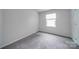 Well-lit bedroom with grey carpet and window at 6232 Hickory Cove Ln, Charlotte, NC 28269