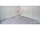Simple bedroom with grey carpet and double closet at 6232 Hickory Cove Ln, Charlotte, NC 28269