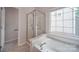 Bathroom with shower, bathtub and window at 6232 Hickory Cove Ln, Charlotte, NC 28269