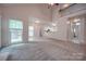 Open living room with vaulted ceiling and view of kitchen at 6232 Hickory Cove Ln, Charlotte, NC 28269