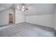 Spacious bedroom with sloped ceilings, carpet, and access to hallway at 6232 Hickory Cove Ln, Charlotte, NC 28269