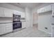 White kitchen with stainless steel appliances and granite countertops at 6232 Hickory Cove Ln, Charlotte, NC 28269