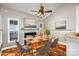Virtually staged dining area with fireplace and adjacent kitchen at 1804 Robinwood Village Dr, Gastonia, NC 28054