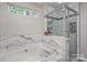 Bathroom with soaking tub, shower, and marble tile at 1804 Robinwood Village Dr, Gastonia, NC 28054