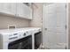Laundry room with washer, dryer, and overhead cabinets at 1804 Robinwood Village Dr, Gastonia, NC 28054