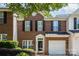 Brick front townhouse with a two-car garage and manicured landscaping at 1804 Robinwood Village Dr, Gastonia, NC 28054