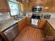 This kitchen boasts stainless steel appliances and granite countertops at 231 Badin View Rd, New London, NC 28127