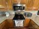 Modern kitchen with stainless steel appliances and granite countertops at 231 Badin View Rd, New London, NC 28127