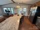 Open kitchen with island, granite counters, and stainless steel appliances at 231 Badin View Rd, New London, NC 28127