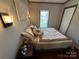 Cozy bedroom with a queen-size bed and bedside table at 231 Badin View Rd, New London, NC 28127