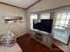 Bright living room with bay window, TV, and comfortable seating at 231 Badin View Rd, New London, NC 28127