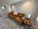 Cozy basement living area with brown couch and side table at 231 Badin View Rd, New London, NC 28127
