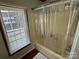 Bathroom with tub, shower, and window providing natural light at 231 Badin View Rd, New London, NC 28127