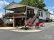 Single-story home with large deck and red chairs at 231 Badin View Rd, New London, NC 28127
