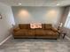 Spacious basement sitting area with brown couch at 231 Badin View Rd, New London, NC 28127