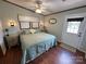 Spacious bedroom with a king-size bed, two nightstands, and a door leading outside at 231 Badin View Rd, New London, NC 28127