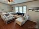 Open living area showcasing a comfy sectional sofa and wood floors at 231 Badin View Rd, New London, NC 28127