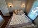 Well-lit bedroom with a queen-size bed, nightstand, and window at 231 Badin View Rd, New London, NC 28127