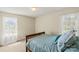 Bright bedroom with a double bed, built-in shelving and two windows at 1000 Hawkinstown Rd, Salisbury, NC 28144