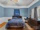 Blue bedroom with hardwood floors and ceiling fan at 510 5Th St, Spencer, NC 28159