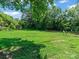 Large grassy backyard with mature trees and shed at 510 5Th St, Spencer, NC 28159