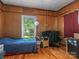 Small bedroom with wood walls and hardwood floors at 510 5Th St, Spencer, NC 28159