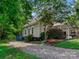 Quaint home with gray siding and a gravel driveway at 510 5Th St, Spencer, NC 28159