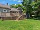 Spacious deck overlooks fenced backyard with shed at 510 5Th St, Spencer, NC 28159